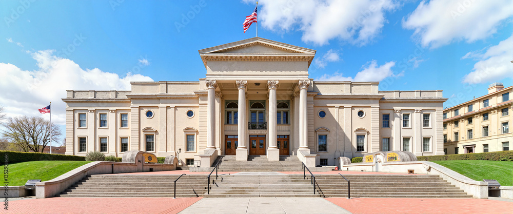 Naklejka premium Grand neoclassical museum entrance on a sunny day, cultural heritage