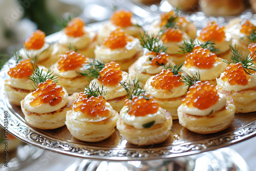 Russian blini pancakes with red caviar and dill garnish on antique serving dish