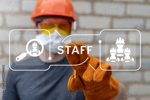 Worker using virtual touch screen push text: STAFF. Industrial Staff concept. Professional Team Engineer Worker Work Industry Staffing. HR for manufacturing.
