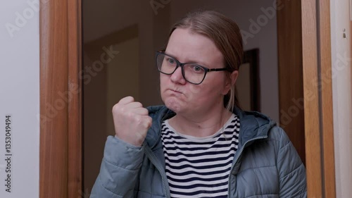 Woman with glasses, strict mother in doorway, shocked by a prank, shaking her fist, indignant, opening her mouth in amazement Teacher returned to class and scolded her for poor discipline Family abuse