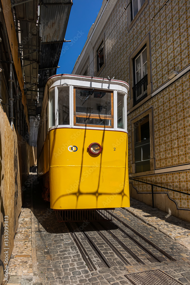 Famous retro yellow funicular in the old town. The yellow funicular operating since 1885, is a tourist attraction. Lisbon, Portugal.