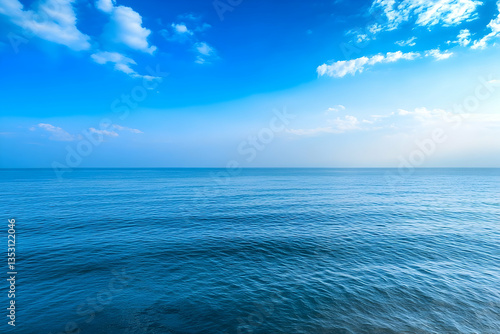 Calm ocean under a blue sky, peaceful seascape, travel background