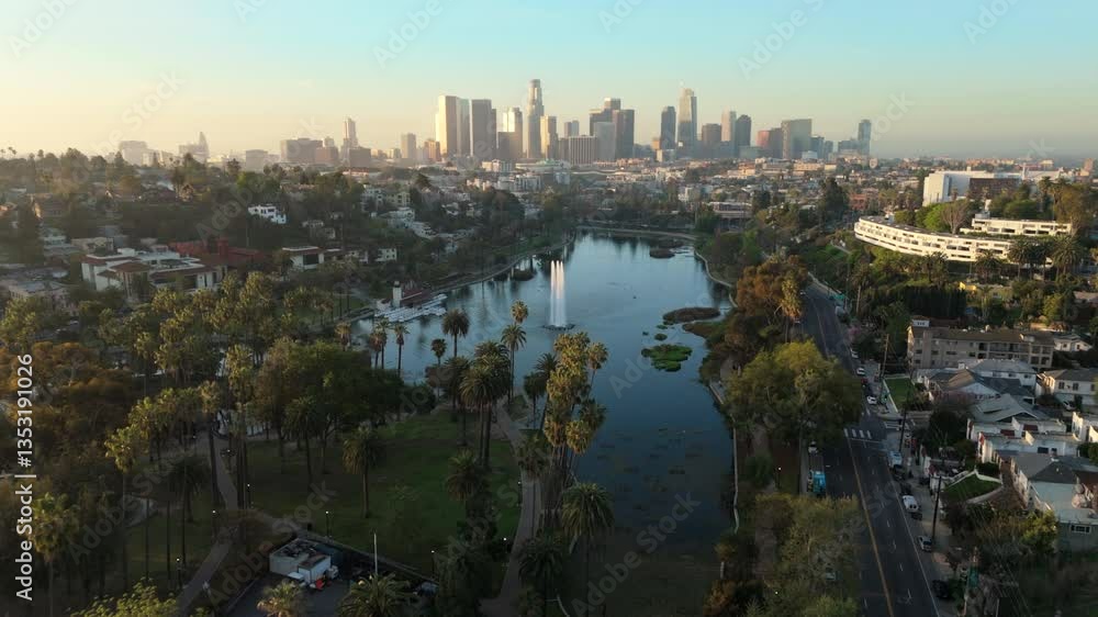 Breathtaking aerial drone footage captured in the morning light of Echo Park Lake highlights the stunning beauty and vibrant landscape of downtown Los Angeles skyline, California, in all its glory