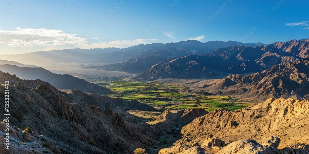 Fototapeta premium A majestic mountain range with soft sunlight casting long shadows over the valleys