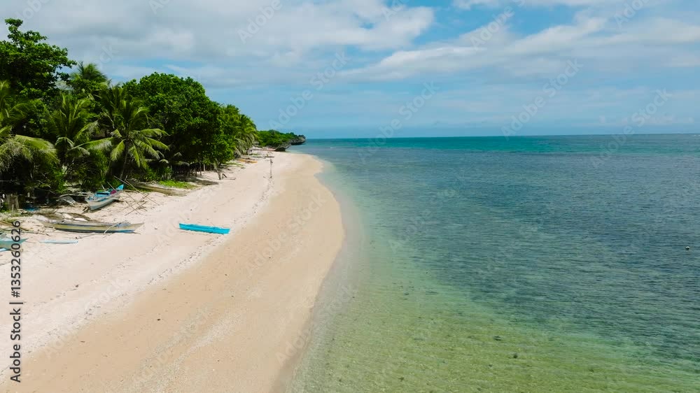 Stunning coastline featuring palm trees and crystal clear waters along a sandy beach. Lanas Beach, San Jose, Romblon, Philippines. Stunning coastline featuring palm trees and crystal clear waters along a sandy beach. Lanas Beach, San Jose, Romblon, Philippines.