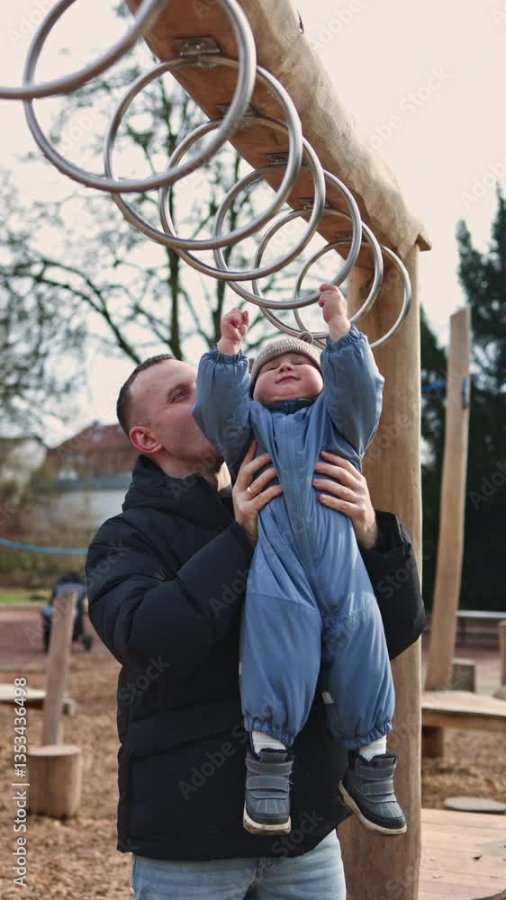 Little boy 1 year old walking in the park with dad. Autumn family walk of dad and toddler boy. Child development. Little boy 1 year old walking in the park with dad. Autumn family walk of dad and toddler boy. Child development.
