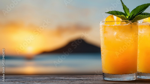 Drink summer beach lifestyle Refreshing orange drink with mint leaves against a beautiful sunset.