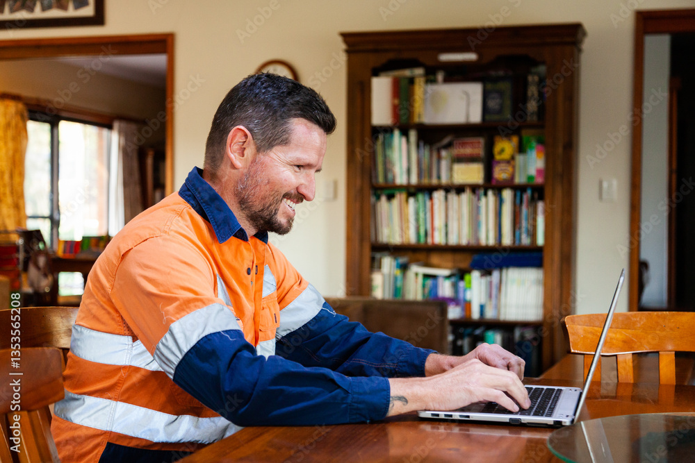 Happy man in his thirties working from home on laptop Happy man in his thirties working from home on laptop