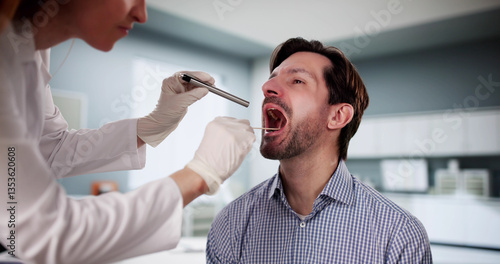 Bild auf Leinwand Doctor examining patient's sore throat with tongue depressor during checkup