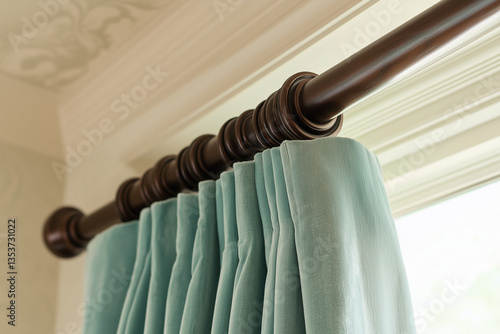 Elegant light aqua velvet drapes harmonize with deep mahogany accents creating a sophisticated, balanced statement