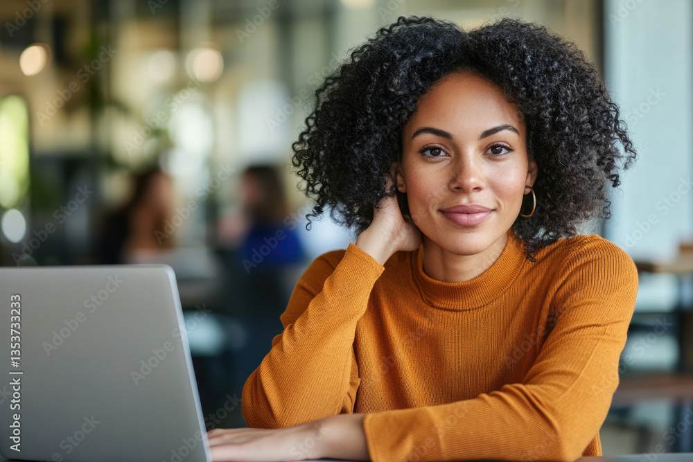 Fototapeta premium Confident woman working on laptop in modern office