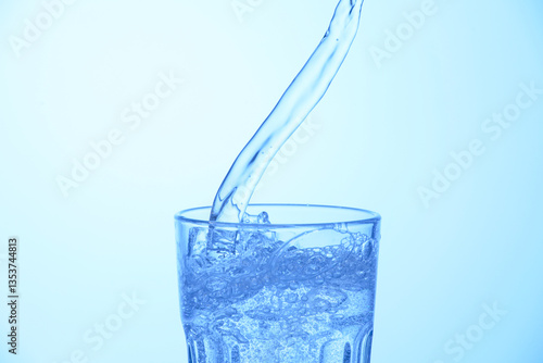 Wallpaper Mural Pouring soda water into glass on light blue background, closeup Torontodigital.ca