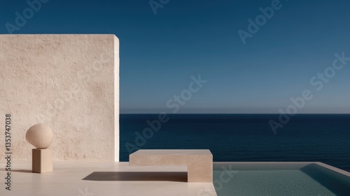 Minimalist coastal terrace with a view.  Light beige structures on a patio overlooking a calm ocean