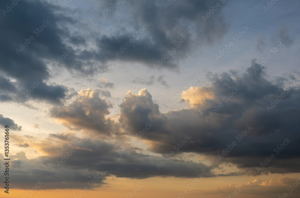 Fototapeta premium Dramatic sunset sky with dark storm clouds and golden sunlight for website hero and background
