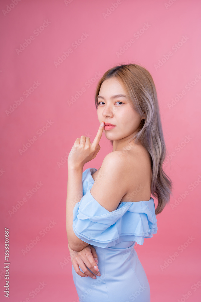 A captivating studio shot of a female model against a pastel pink background serves as an ideal visual for a high-end advertisement or an aesthetically pleasing website layout. A captivating studio shot of a female model against a pastel pink background serves as an ideal visual for a high-end advertisement or an aesthetically pleasing website layout.