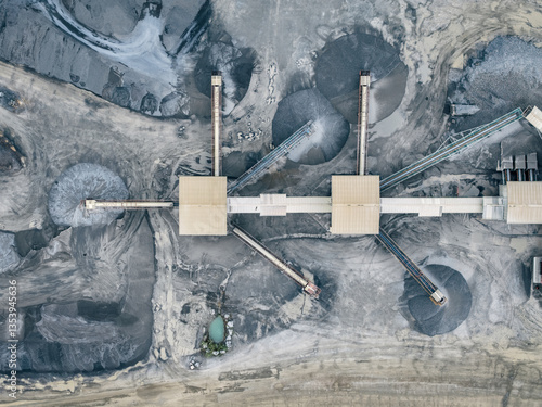 Mining operation from above, showing machinery and mounds of extracted resources.