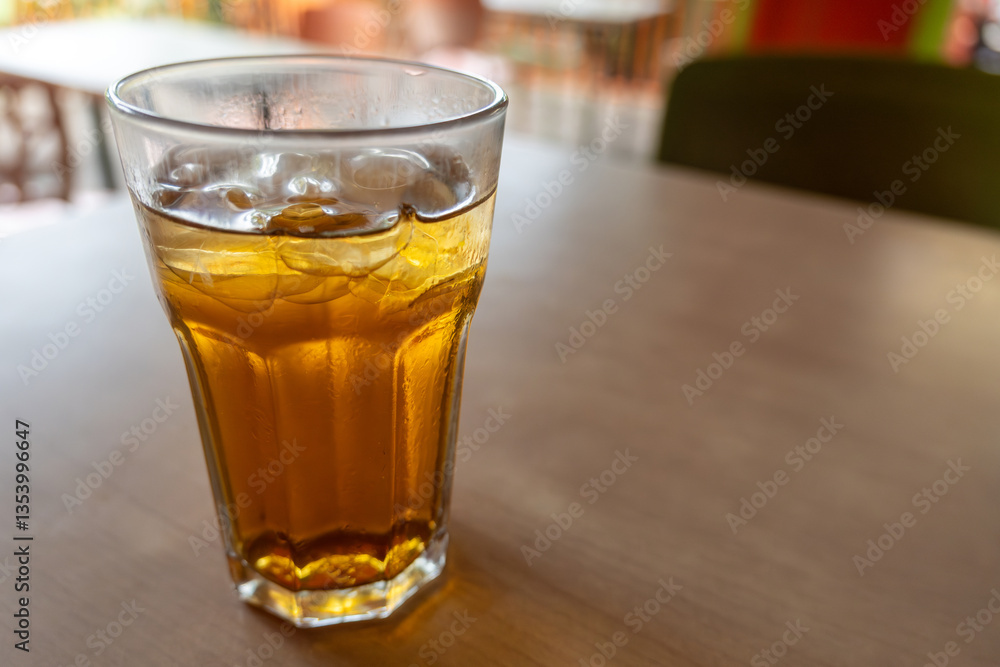 Glass of tea is sitting on a table Glass of tea is sitting on a table