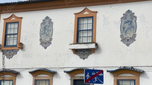Aveiro, Portugal - February 20, 2025: Historic building with traditional blue azulejos and vivid blue doors in Aveiro.