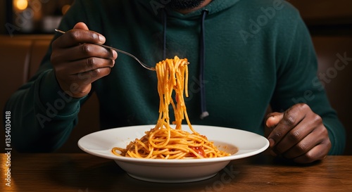 Male customer is eating spaghetti with tomato sauce