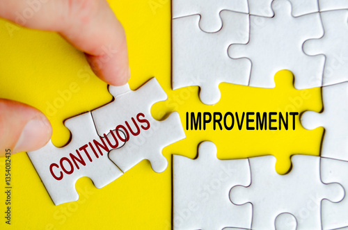 Continuous Improvement text on jigsaw puzzle. Business strategy and improvement concept