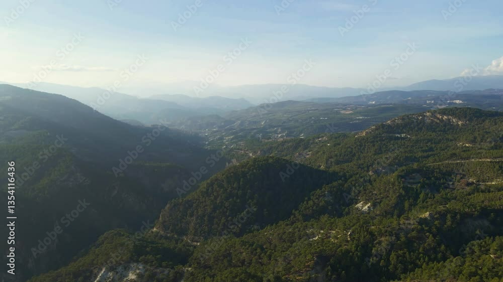 Aerial view the mountains are covered in trees and the sky is clear Aerial view the mountains are covered in trees and the sky is clear