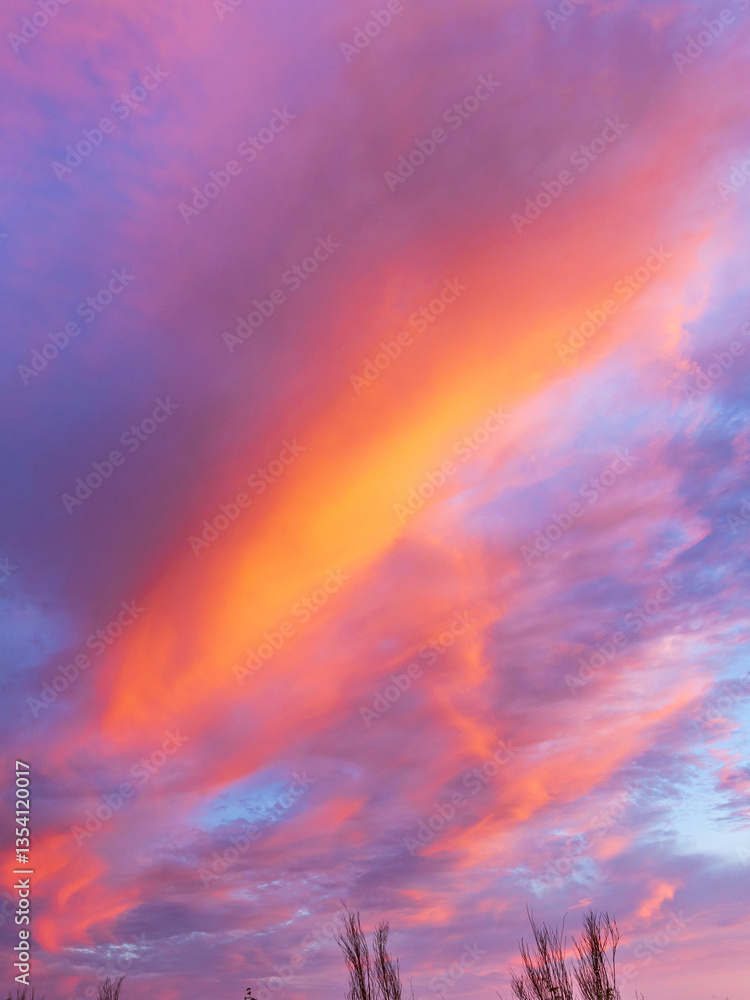A beautiful pink and orange sky with a long orange streak A beautiful pink and orange sky with a long orange streak