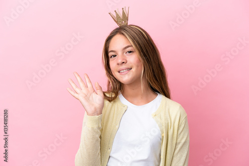 Wallpaper Mural Little princess with crown isolated on pink background saluting with hand with happy expression Torontodigital.ca