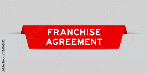 Red color inserted label with word franchise agreement on gray background