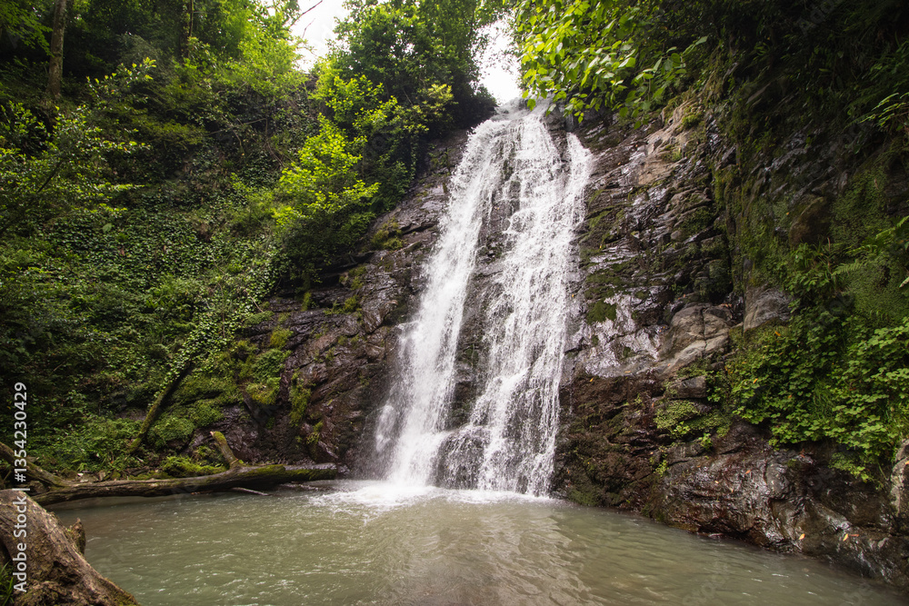 Fototapeta premium Beautiful Kapnistavi waterfall in the green forest. Adjara, Georgia