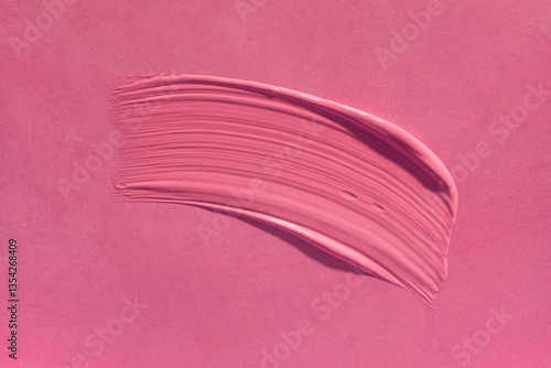 Lipstick or creamy bluster smudge swatch isolated on pink background