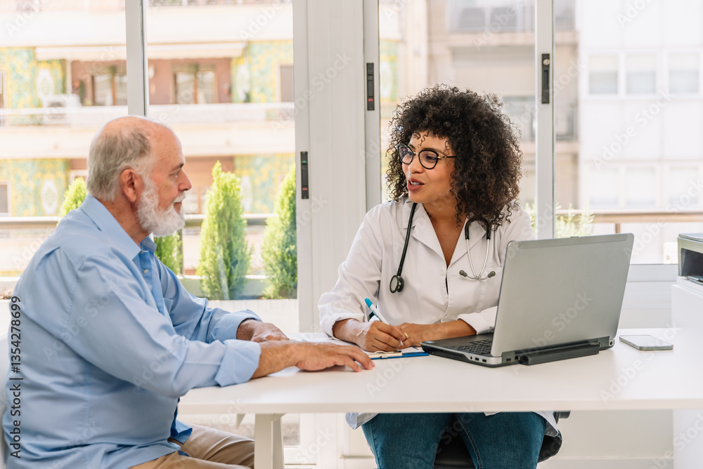 Fototapeta premium Afro-american female doctor explaining diagnosis to senior patient during medical consultation in clinic