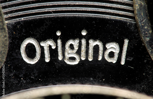 An old, hundred-year-old engraved inscription on an antique lens