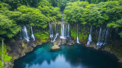 A stunning high-definition photograph of a lush green forest, featuring a central stream flowing down from a waterfall above, forming multiple small cascades and flows.