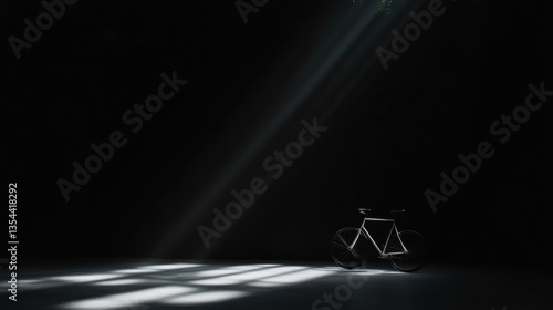 A single bicycle, bathed in light, in a dark room