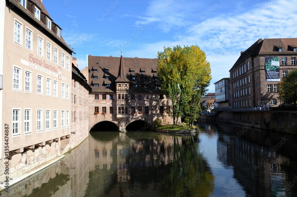 Obraz premium Nuremberg, Germany 10.17.2019: Hospice of the Holy Spirit (Heilig-Geist-Spital) in the center of Nuremberg on the banks of the Pegnitz river