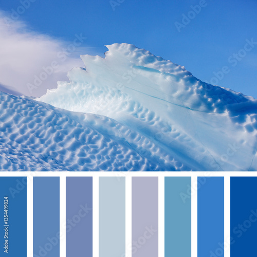 Tableau sur toile Jagged edge detail of a blue iceberg against blue sky and cloud background