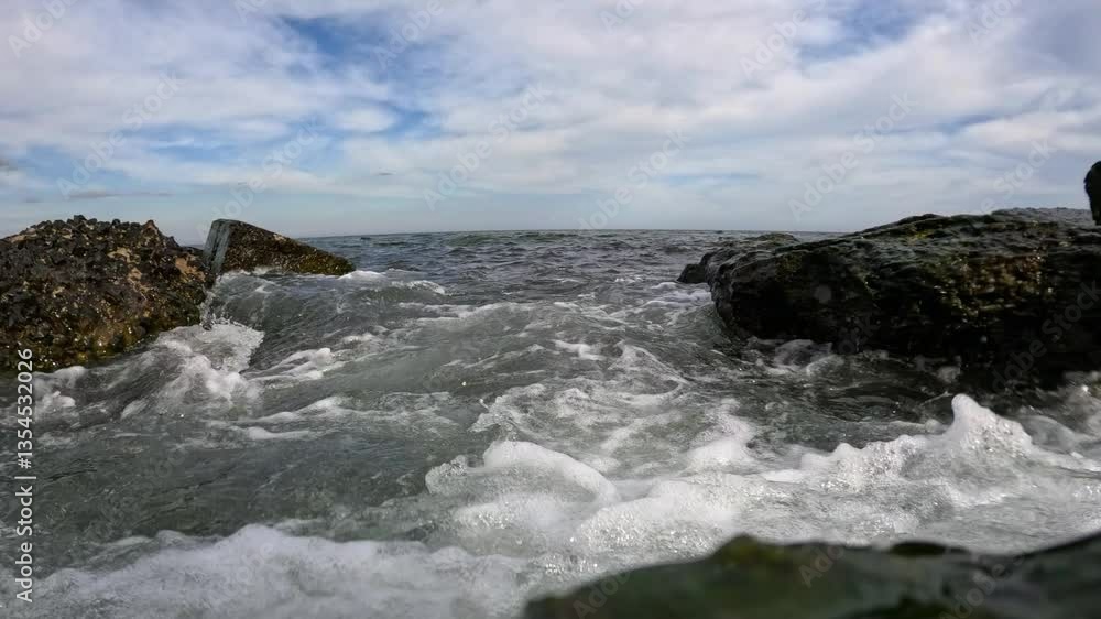 Hydrodynamics of water masses, Waves flood a video camera and stones during a storm, overgrown with algae, Black Sea Hydrodynamics of water masses, Waves flood a video camera and stones during a storm, overgrown with algae, Black Sea