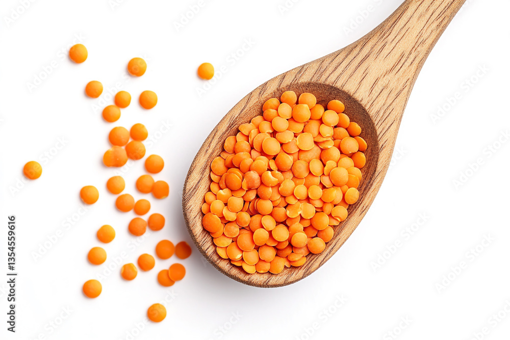 Top view of a wooden spoon with orange-red lentils on a white background. Top view of a wooden spoon with orange-red lentils on a white background.