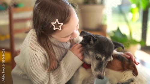 7 year old girl hugs two cute dogs