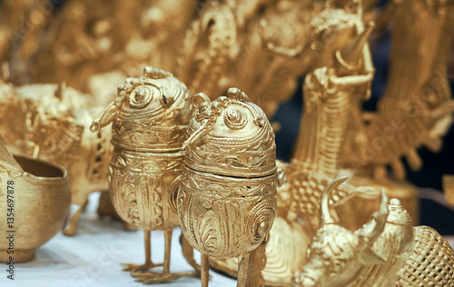 Intricately designed Dhokra handicrafts for sale at a craft fair in Kolkata. Dokra, a primitive form of art, where Brass (or bronze) made figurines are made from lost wax casting process.