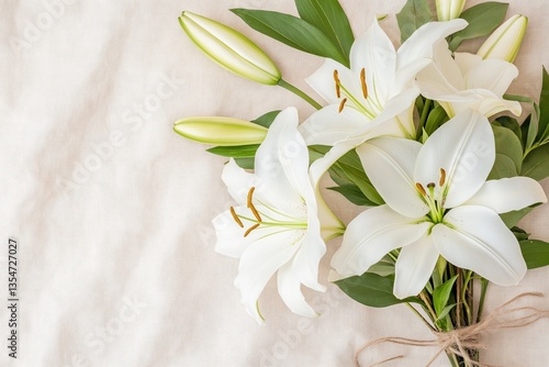 Elegant white lily bouquet on soft fabric background  