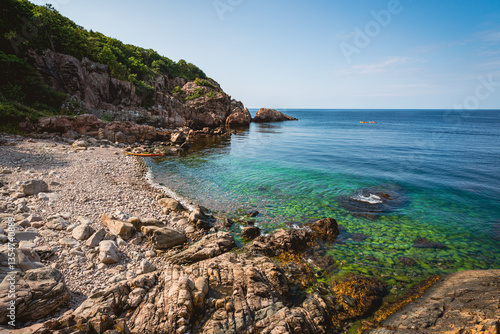 Scenic view of cliffs and rocky beach at Kullaberg Nature Reserve in Sweden. Popular tourist destination for hiking, kayaking and fishing.