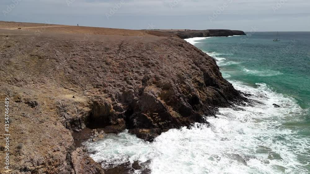 Lanzarote, Canary Islands Aerial View. Southern coast of Lanzarote, near Playa Blanca and Playa Mujeres, with turquoise waters, golden sand, and volcanic cliffs.  
