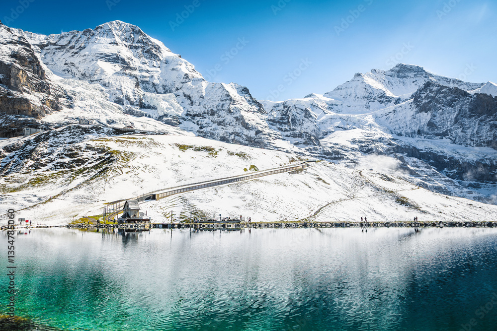Turquoise Fallbodensee lake and high snowy mountains, Grindelwald, Switzerland