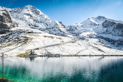 Turquoise Fallbodensee lake and high snowy mountains, Grindelwald, Switzerland