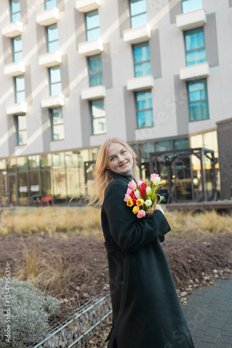 Obraz na płótnie Beautiful happy Caucasian woman smelling bunch of tulips with closed eyes. High quality w salonie