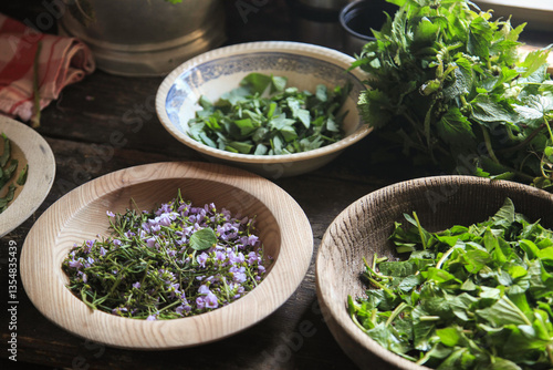 Freshly collected herbs for cooking in old bowls