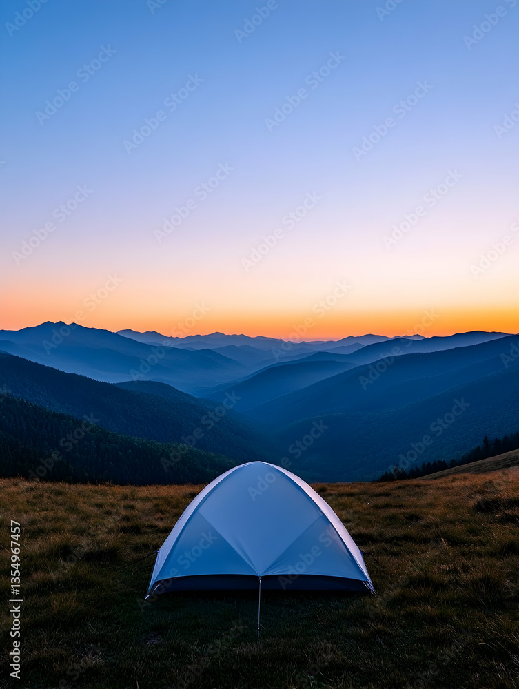 Serene sunrise over majestic mountain range, viewed from a lone tent pitched in a grassy meadow Serene sunrise over majestic mountain range, viewed from a lone tent pitched in a grassy meadow