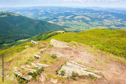 Obraz na płótnie mountain landscape of ukraine in summer. outdoor adventure on a sunny day. alpine nature scenery with rock on the hill and beautiful view in to the valley. travel to borzhava ridge w salonie