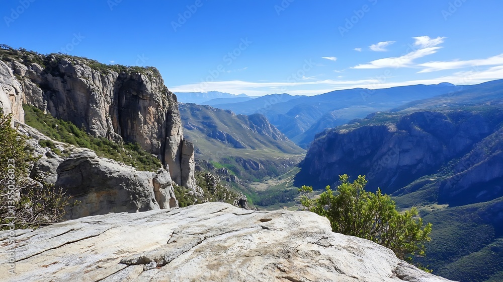 Fototapeta premium Breathtaking mountain valley view showcasing cliffs and a vibrant landscape under a clear blue sky : Generative AI